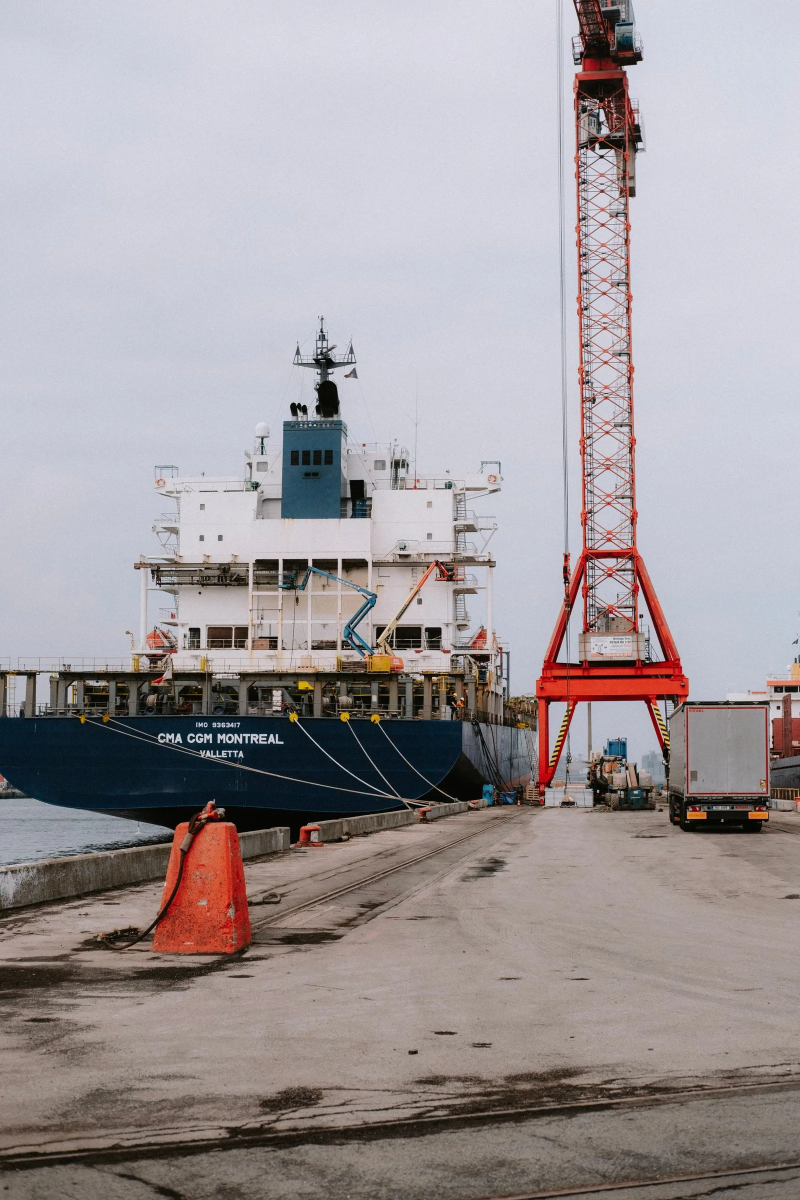 Container vessel alongside cranes at a working port